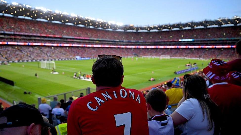 An Irish supporter wearing a Manchester United jersey with Cantona on the back