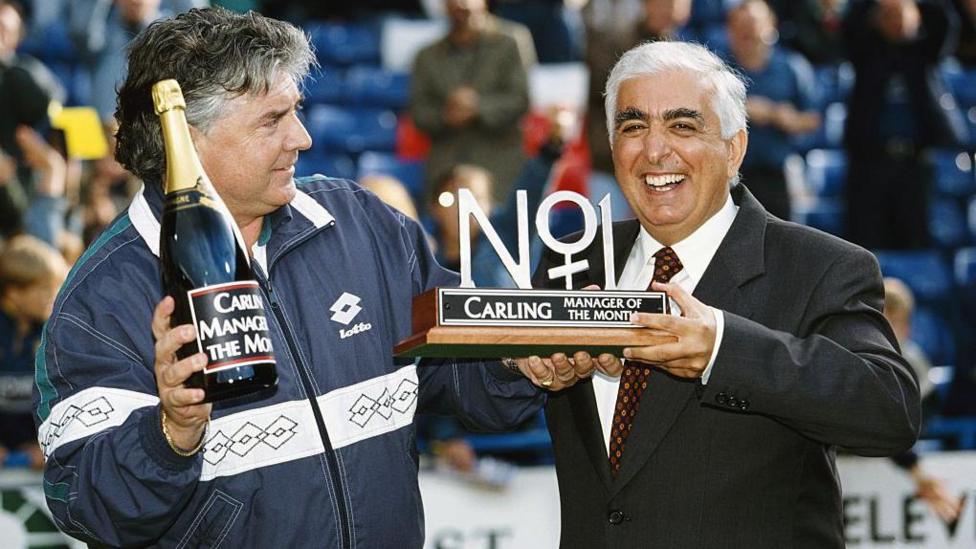 Joe Kinnear is handed his manager of the month award by Sam Hammam