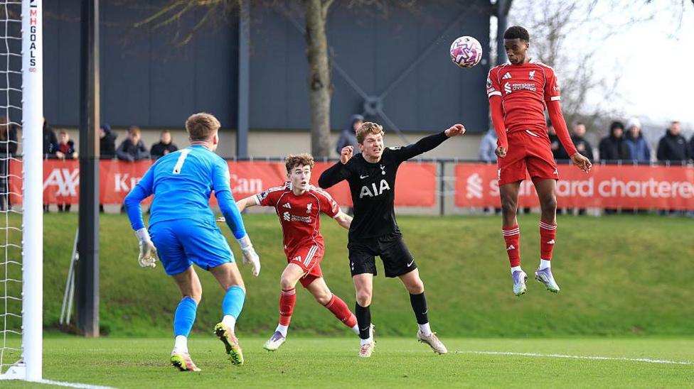 Trey Nyoni leaps to win a header while playing for Liverpool against Tottenham's Under-21 team last season