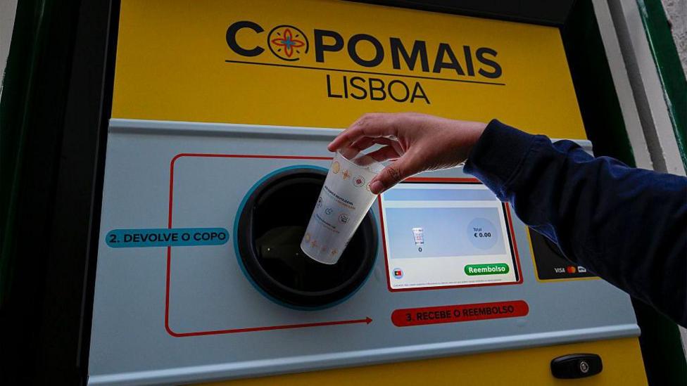 A reverse vending machine for plastic cups in Portugal. It has a computer screen which shows the total amount a person is being reimbursed