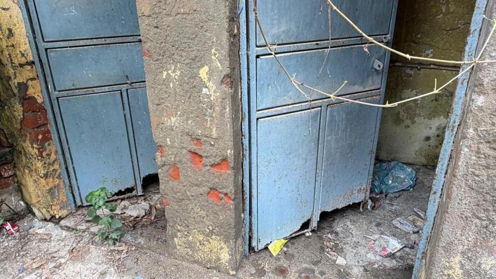 The toilets which are full of trash and no longer in use