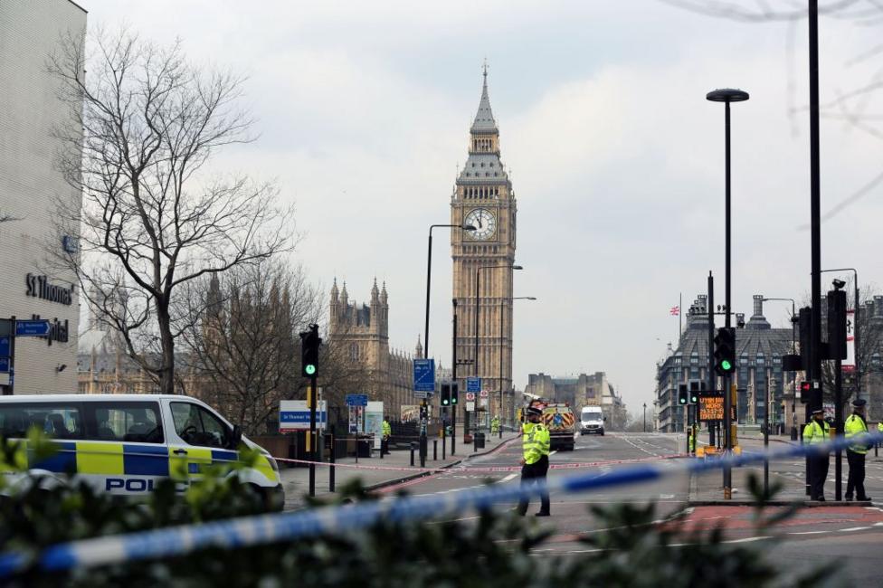 Police take security measures at Westminster Bridge after a car ran over people on the bridge during a terror attack. Police tape covers the entrance to the bridge and police vans and officers are seen in the vicinity.