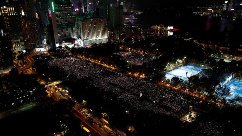 Thousands of people take part in a candlelight vigil at Victoria Park in Hong Kong to mark the 30th anniversary of Beijing's Tiananmen Square crackdown in 1989