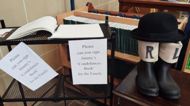 Stage welies and bowler hat by book of condolence