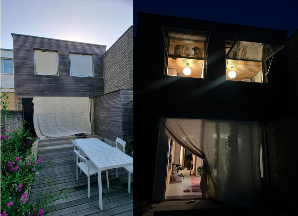 A composite image showing two pictures of the back of a house during the night (right) and during the day (left). The house has wooden panels across the top and two windows, on the ground floor of the house is a large glass patio door. In the day picture it is covered by a sheet, in the night picture this is pulled back and the door and windows are open. In the day picture part of the garden with a white table and chairs, and pink flowered foliage can be seen 