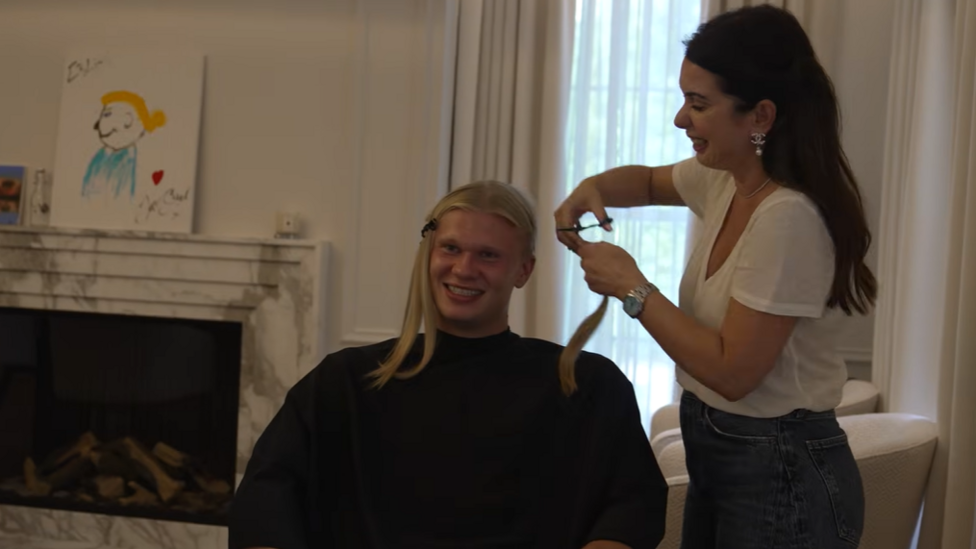 Erling Haaland sat down having a haircut
