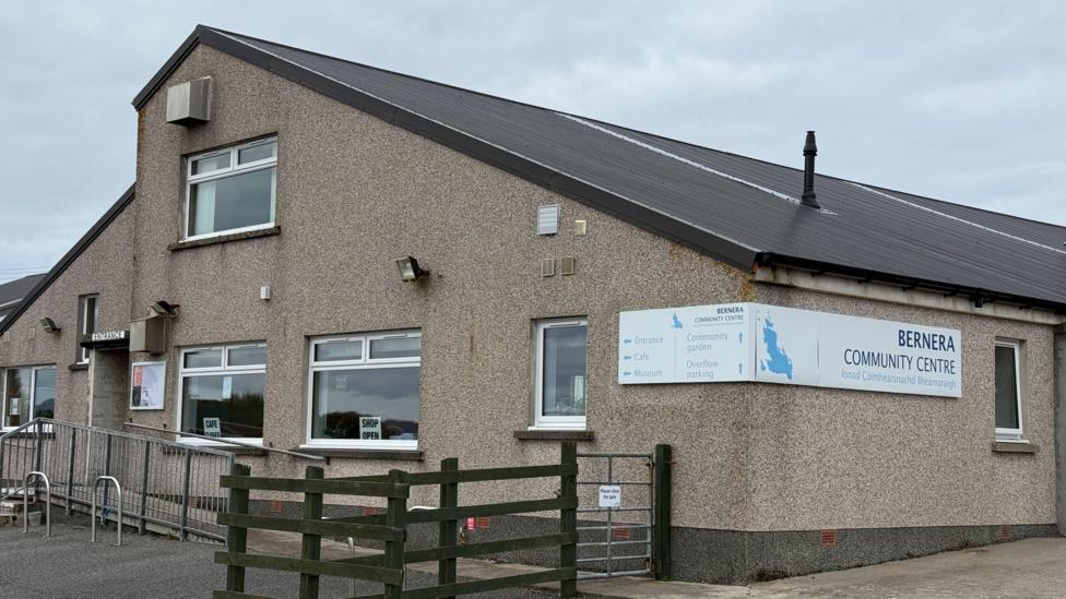 A grey building with a sign that reads Bernera Community Centre