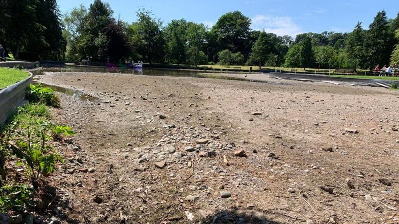 A large expanse of rubble across where there was once a boating pond