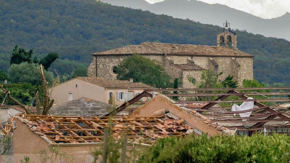 Damaged rooftops on buildings after a tornado struck Pomas, southwestern France on 24 August, 2006.