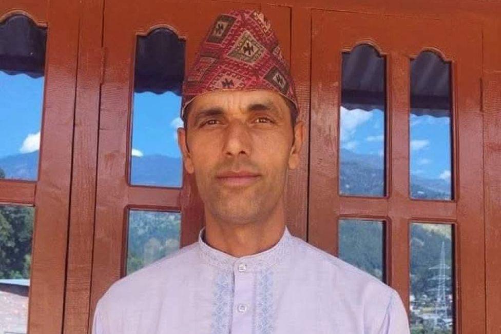 Netra Prasad Lamichhane, a man in traditional dress who escaped the Nepal flash floods.