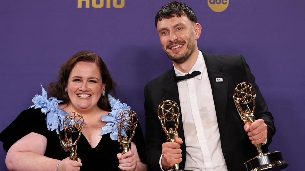 The stars of Baby Reindeer dressed in their finery at the Emmy Awards, holding four statuettes.
