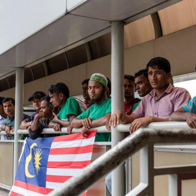 Rohingya men during a 2017 protest in Kuala Lumpur, with a Malaysian flag