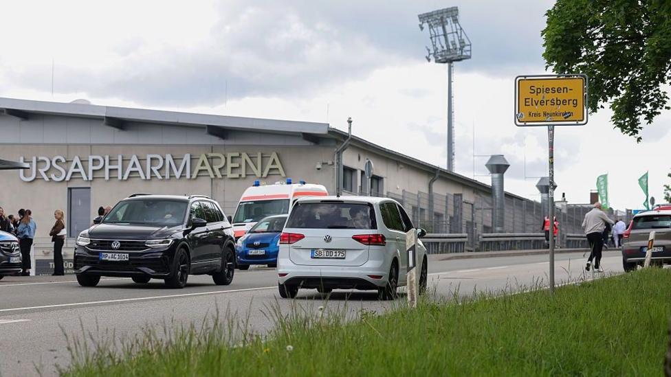 A general view of Elversberg's stadium from the outside, next to a main road with cars