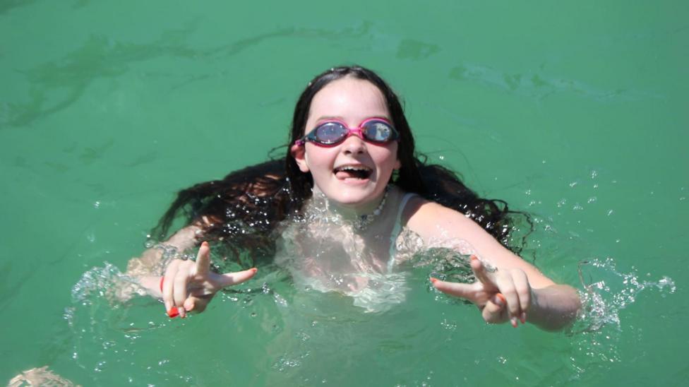 Greta swimming with goggles on