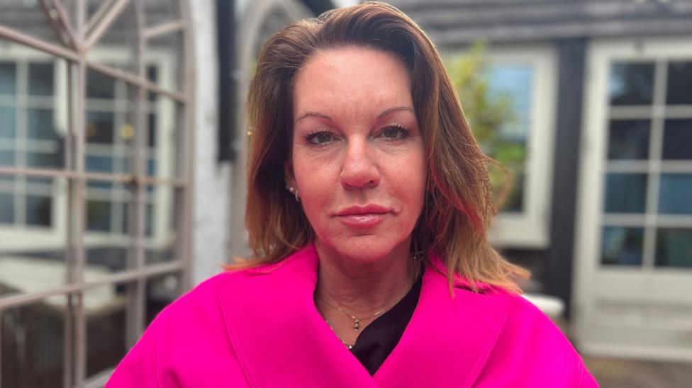 Emma Webber Barnaby Webber's mother looking at the camera, wearing a pink coat