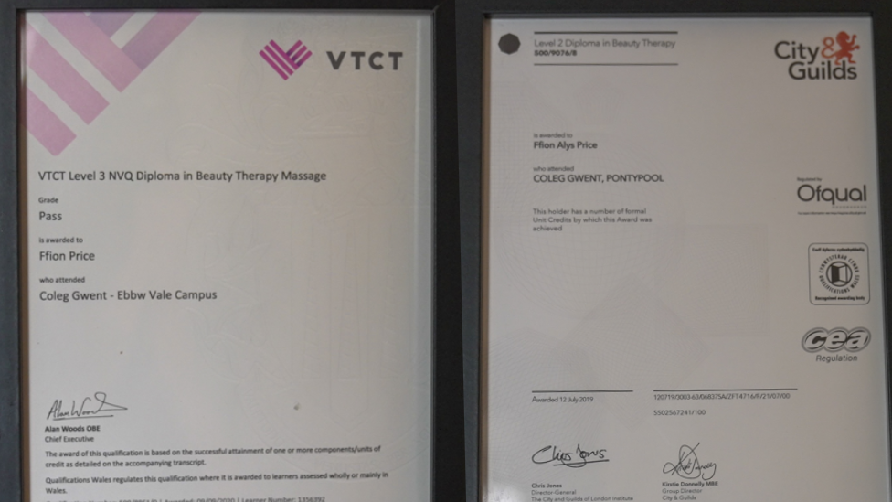 Two training certifcates in black frames. On the left, there is a Level 3 NVQ Diploma in Beauty Therapy Massage addressed to Ffion. On the right, is a Level 2 Diploma. 