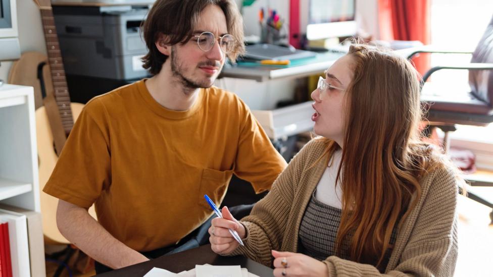 A brother and sister discuss money