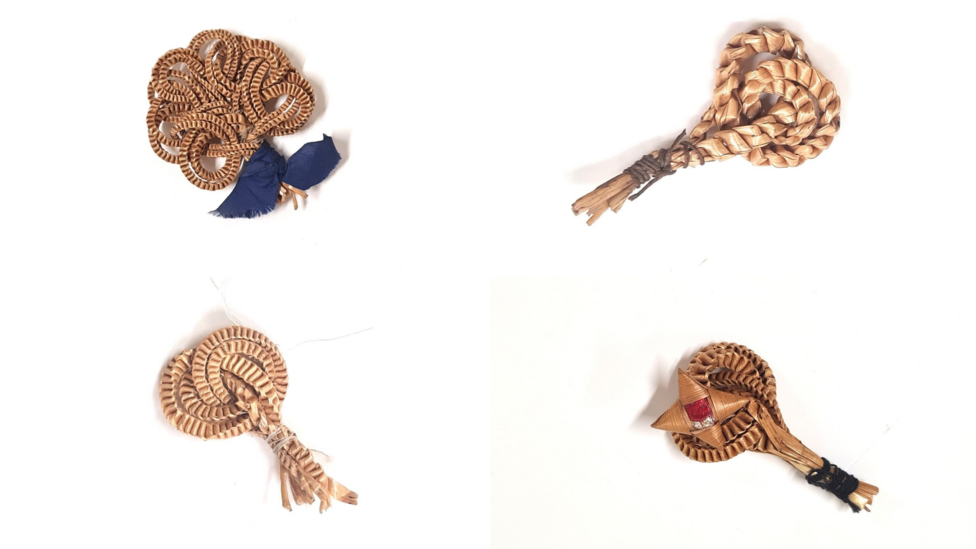 4 small decorative harvest knots made out of plaited and twined straw. Some of them are highly intricate and are decorated with ribbons and coloured stones.