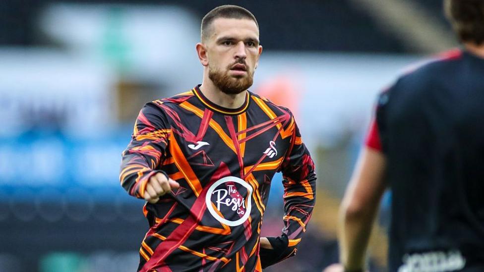 Zan Vipotnik warms up before Swansea's game against Watford