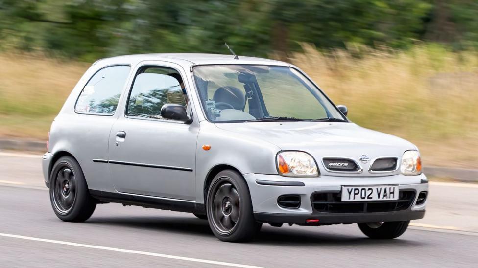 A general view of a silver 2002 Nissan Micra on a road