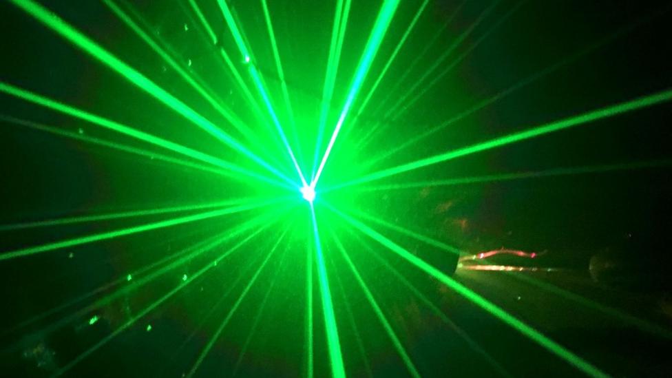 Green laser lights in a dark room