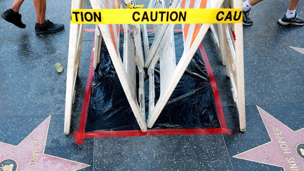 Dolly Parton's star on the Hollywood Walk of Fame on Hollywood Boulevard in Hollywood, covered with black plastic, white barriers and yellow "caution" tape