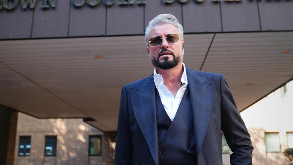 Fashion designer Catalin Botezatu - a middle aged man in a dark blue suit -leaving Southwark Crown Court