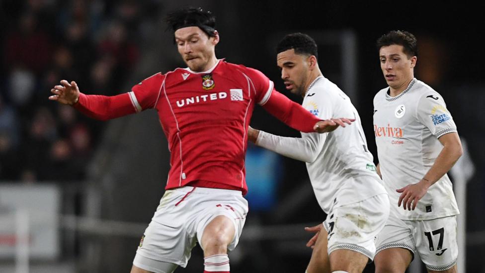 Kieffer Moore holds off Ben Cabango at the Swansea.com Stadium last season