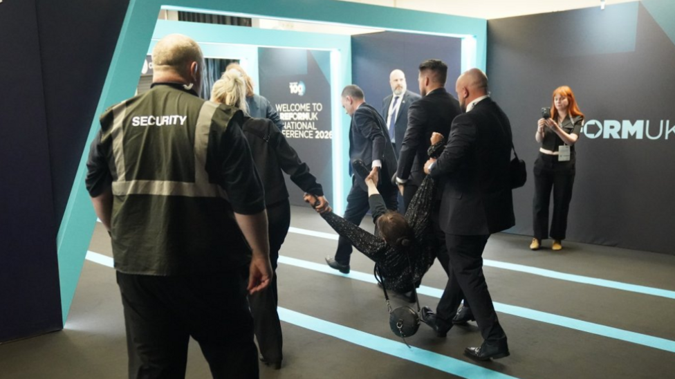 A heckler is removed during Nigel Farage’s speech at the Reform UK National Conference, at the National Exhibition Centre in Birmingham.