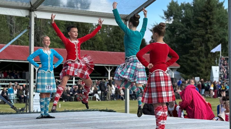 four highland dancers on a stage