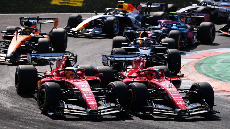 The Ferraris of Charles Leclerc and Lewis Hamilton side by side into the first chicane at the start of the Italian Grand Prix