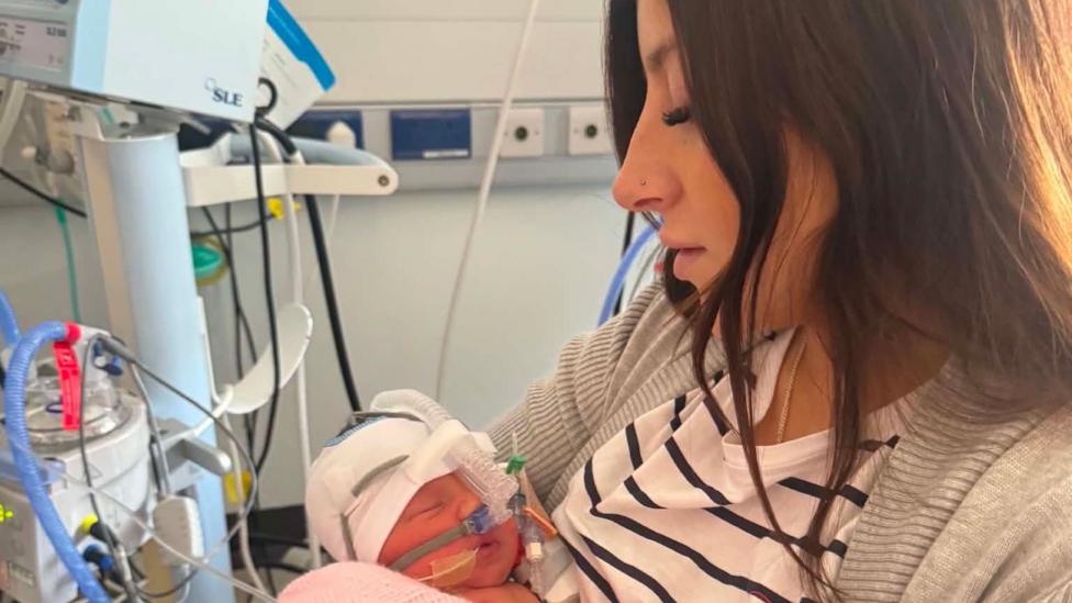 Picture of mother and newborn baby in hospital.
