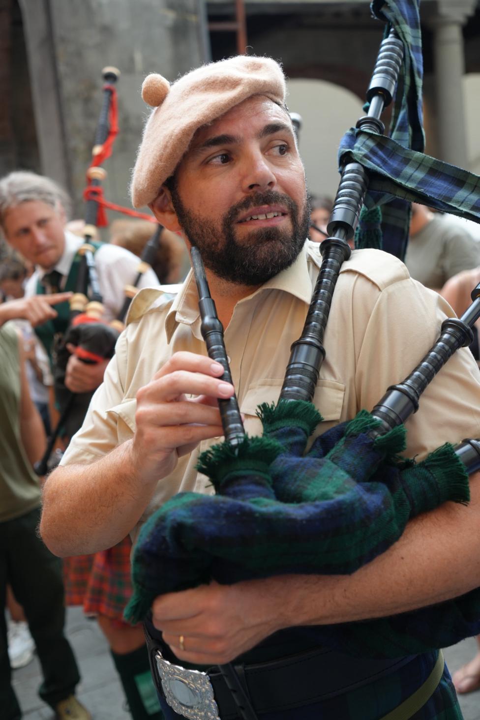 A man in a beret with bagpipes 