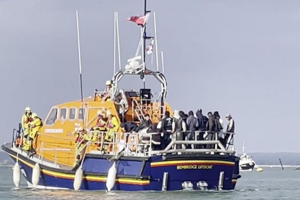 A screen grab of migrants on board an RNLI lifeboat during a rescue operation.