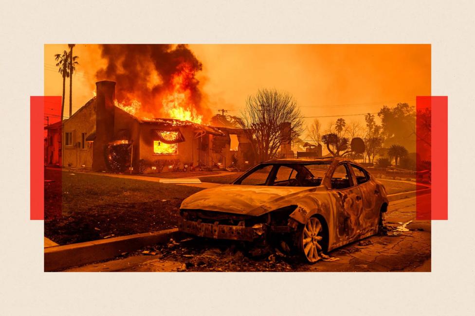 The carcass of a burnt-out car is seen as home burns during the Eaton fire in the Altadena area of Los Angeles county