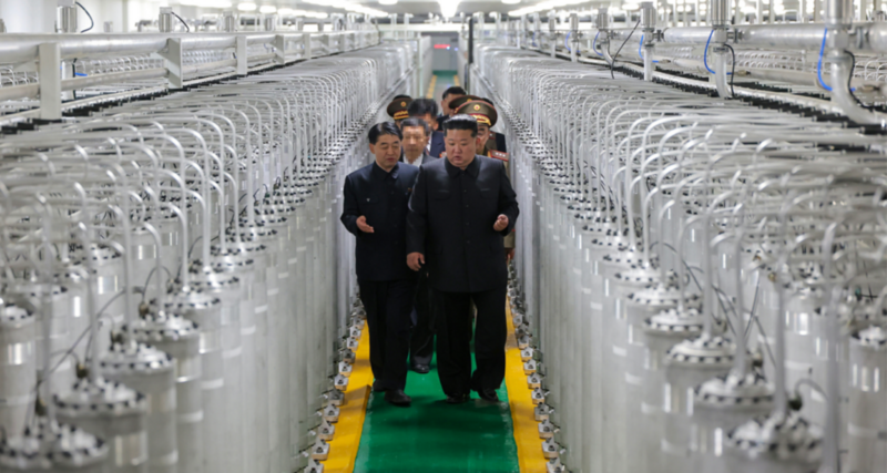 Kim Jong Un and senior North Korean officials walk past rows of centrifuges at a "newly commissioned" nuclear enrichment site