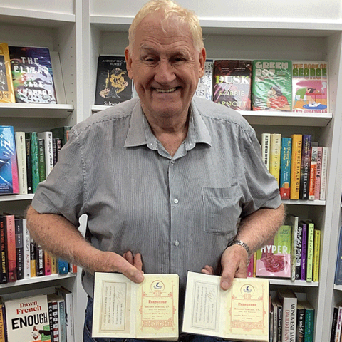 Peter O'Sullivan shows the inside covers of the book