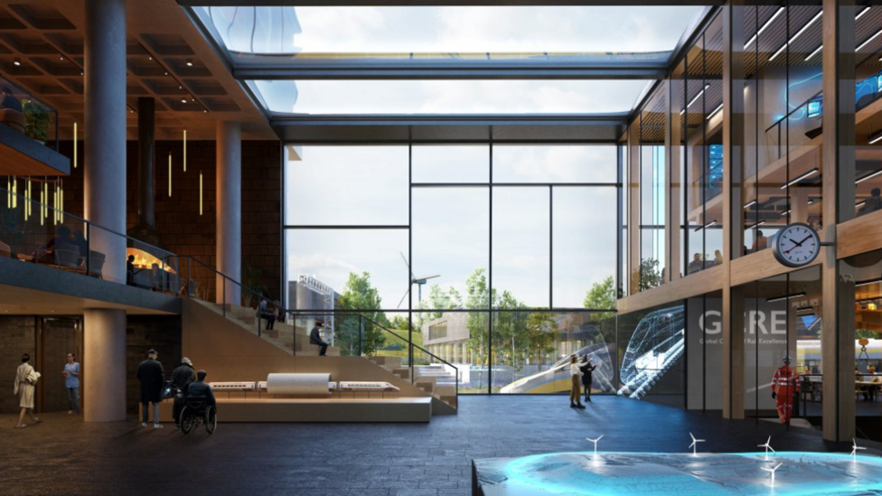 An artist's impression of the proposed GCRE. It is the inside of a two-story building with tall glass windows and models of trains with people walking around