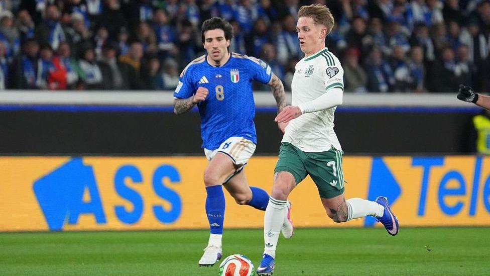 Ethan Galbraith runs with the ball from Sandro Tonali