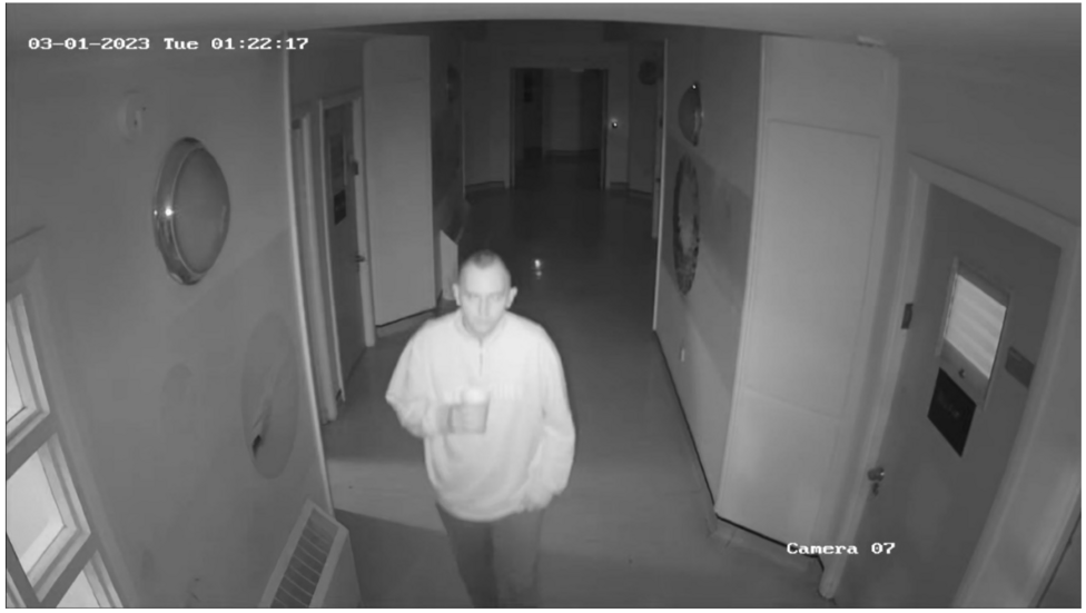 Hugo is seen on CCTV, walking along the hospital corridoor with a cup in his right hand
