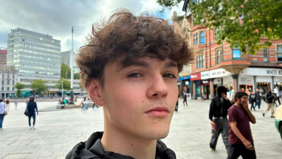 A head and shoulders photo of a young boy in Nottingham city centre