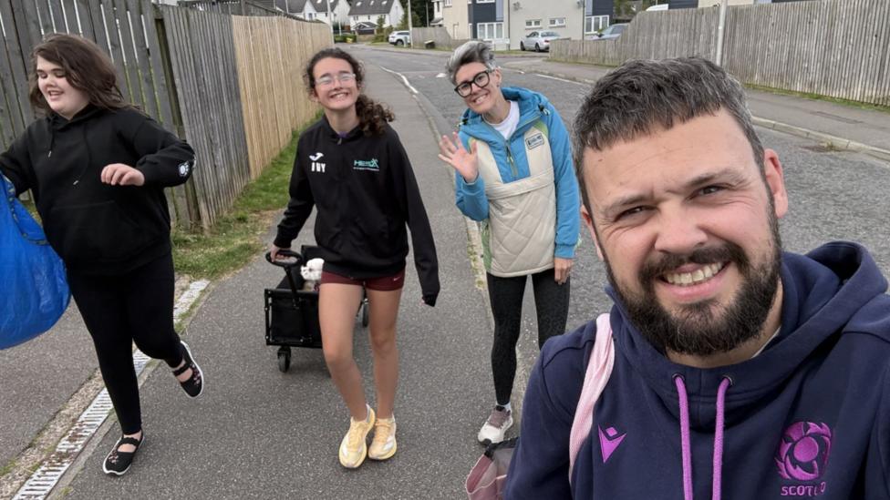 Left to right: Sophie, Ivy, Jaime and Iain in a selfie taken by Iain on a residential street.