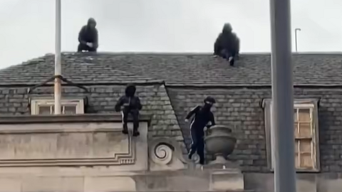 Group of boys dressed in black spotted on the roof of the former Debenhams store in Nottingham city centre.