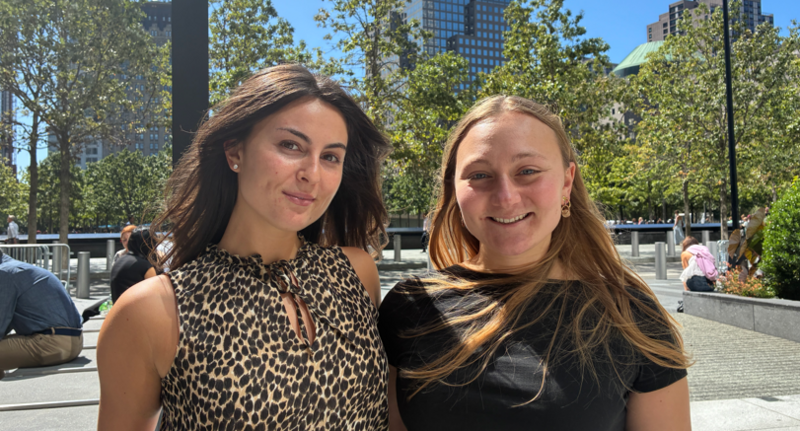 Two women smile at the camera