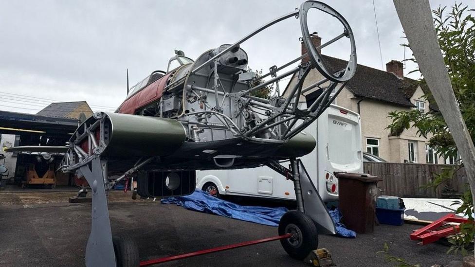 The bare frame of a 1941 Hawker Hurricane, sat on a driveway.