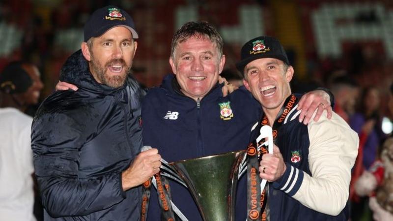 Wrexham co-owner Ryan Reynolds (left), manager Phil Parkinson (centre) and co-owner Rob Mac (right)
