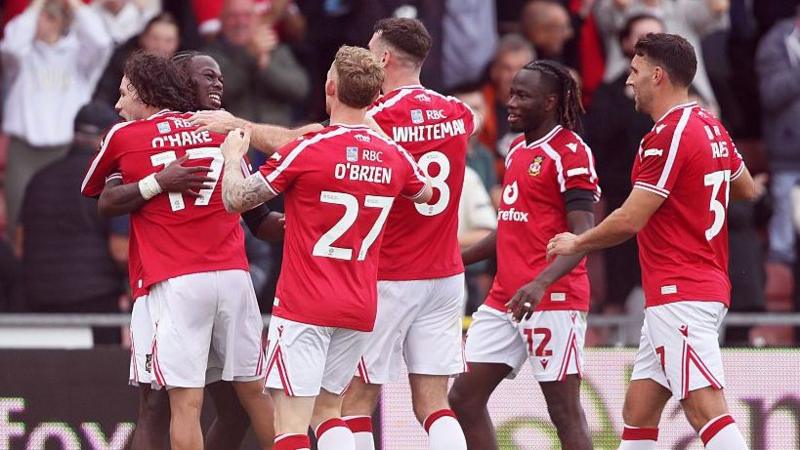 Wrexham players Callum O'Hare, Lewis O'Brien, Ben Whiteman, Issa Kabore and Matty James celebrate with Jacques Ekomie (left, hidden)