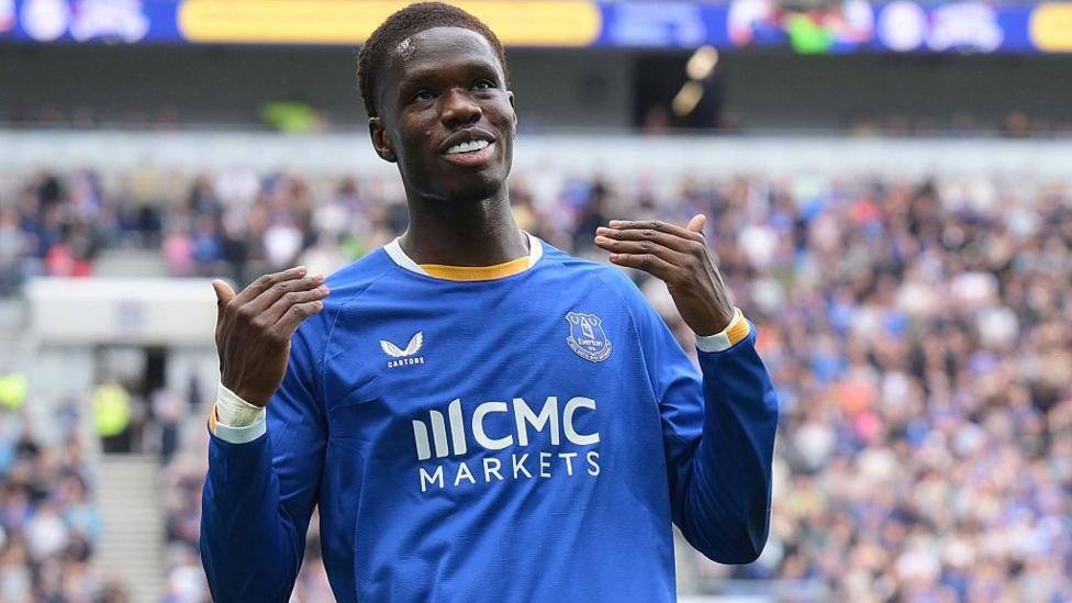 Thierno Barry, in blue kit, celebrates with a beckoning gesture after what he thought was his second Everton goal of the afternoon - but it was disallowed