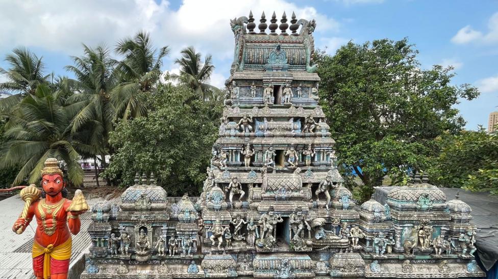 A Hindu statue in front of a shrine in India
