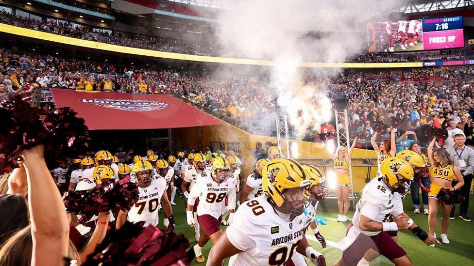 The Arizona State Sun Devils run out before the Union Jack Classic in 2026
